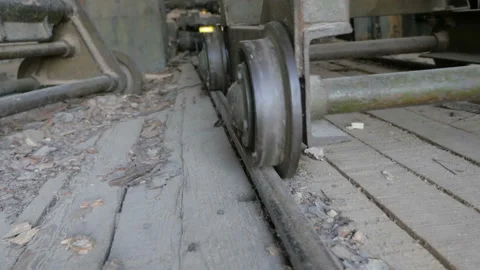Moving old trolley for transporting materials, products, raw on rails Stock Footage 89987938