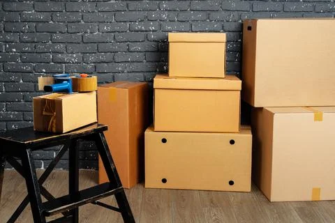 Moving in or moving out concept. Stack of boxes and packed furniture 스톡 사진
