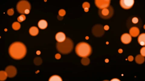 Moving orange particles background with bokeh seamless loop animation on blac Stock Footage 219596875