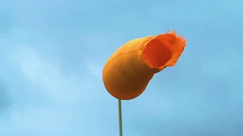 Moving Orange Wind Sock in a Stormy Day, Loop Stock Footage 156398111