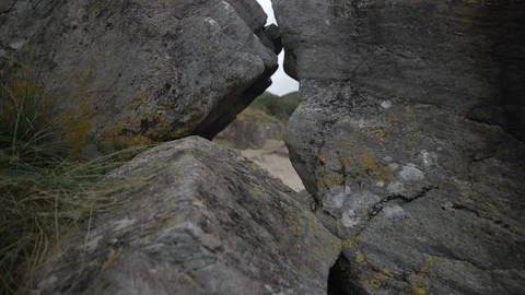 Moving over and through Beach rocks Stock Footage 106927488