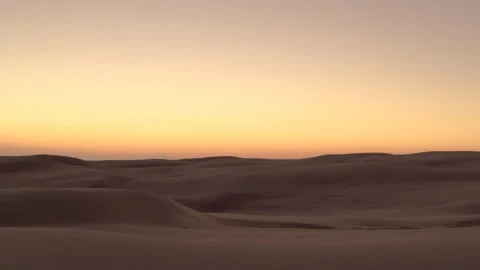 Moving over dunes in desert at sunset aerial Stock Footage 264501184