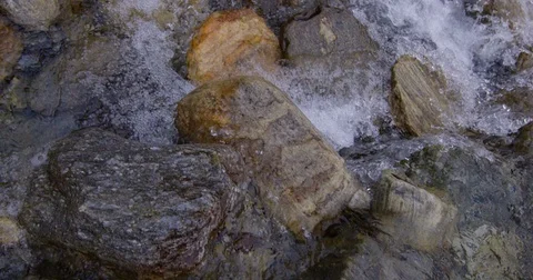 Moving over foaming river water with stones, high frame rate Stock Footage 69936725