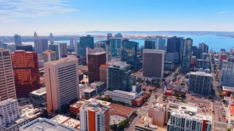 Moving over low-density urban area with diverse high-rise buildings. Approaching Vídeos de archivo 347012252
