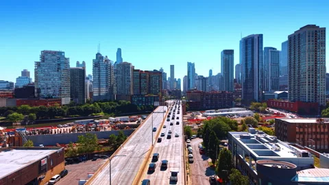 Moving over the multiple cars going by the wide-lane road. High-rise skyline of Stock Footage 338138138