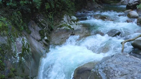 Moving over a river with crystal clear water and small cascades Stock Footage 146351922