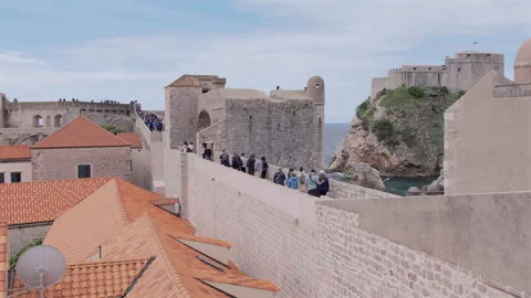 Moving panning view of people walking at Dubrovnik City Wall, Croatia Video stock 283180230