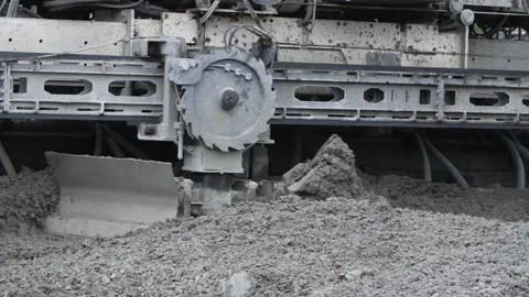 Moving part of slipform paver spreading concrete mass over motorway surface Video stock 158049587
