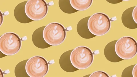 Moving pattern of coffee latte cups with a heart-shaped art Stock Footage 239535393