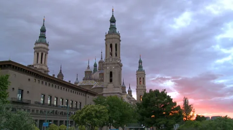 Moving pink clouds over baroque religious monument at sunset Stock Footage 38716647