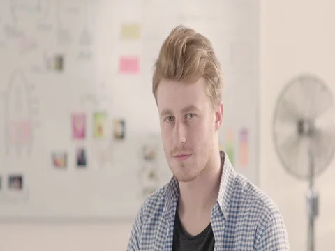 Moving portrait of a man in a startup office - track right. Stock Footage 72832391