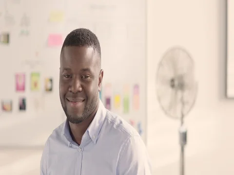 Moving portrait of a man in a startup office - track left. Stock Footage 72833221