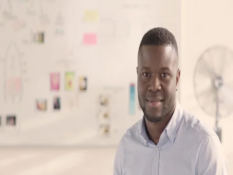 Moving portrait of a man in a startup office - track right. Stock Footage 72833372