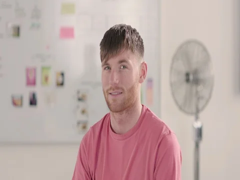 Moving portrait of a man in a startup office - track right. Stock Footage 72834145