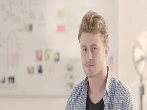 Moving portrait of a man in a startup office - track right. Stock Footage 72835261