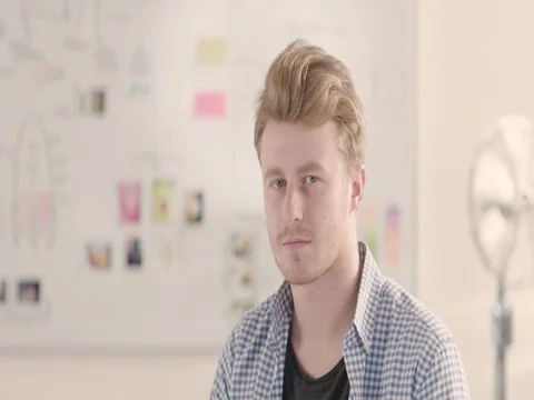 Moving portrait of a man in a startup office - track right. Stock Footage 72840165