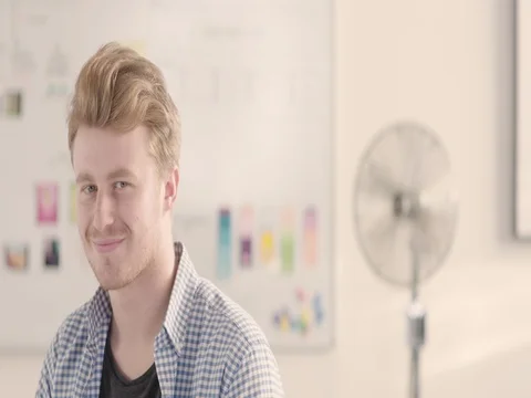 Moving portrait of a man in a startup office - track left. Stock Footage 72840992