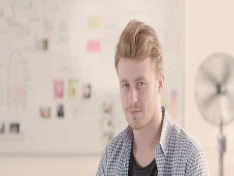 Moving portrait of a man in a startup office - track right. Stock Footage 72841077