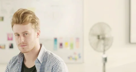 Moving portrait of a man in a startup office - track right. Stock Footage 92168355