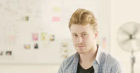 Moving portrait of a man in a startup office - track right. Stock Footage 92168917
