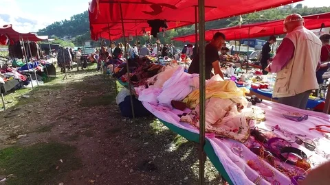 Moving POV shot through a large outdoor gypsy flea market in the Alps of Stock Footage 75692544