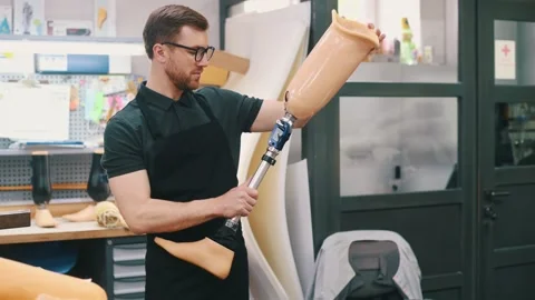 Moving the prosthesis. Technician working in modern laboratory. Stock Footage 243634361