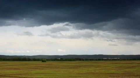 Moving rain clouds over field Stock Footage 50449133