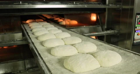 Moving The Raw Bread Dough Into The Pre-Heated Deck Oven Using A Handheld Stock Footage 142112188