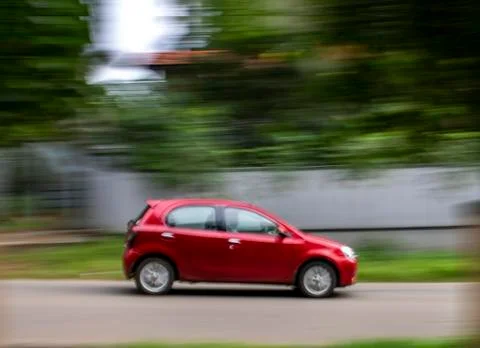 Moving red car Stock Photos