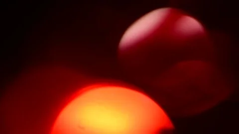 Moving red defocused lights through dark background. Stock Footage 83697485