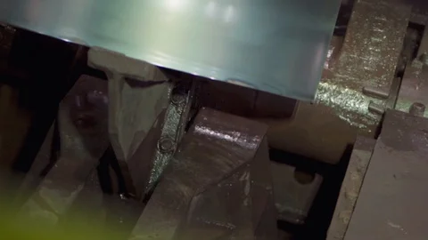 Moving a roll of metal sheets on a conveyor. Stock Footage 130028122