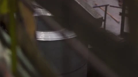 Moving a roll of metal sheets on a conveyor. Видео 187571856
