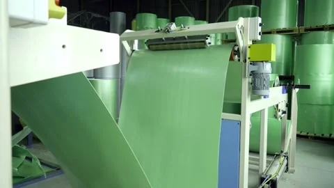 Moving roller with flat polyethylene green film Stock Footage 148437797