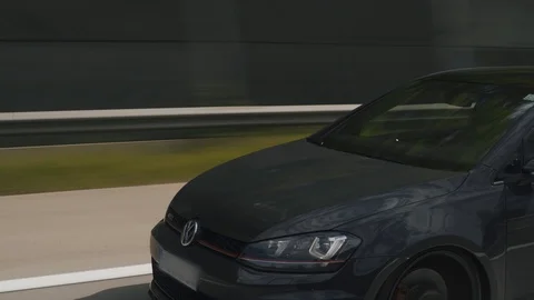 Moving rolling shot of a custom VW Volkswagen Golf GTI car driving on highway Video stock 127375809