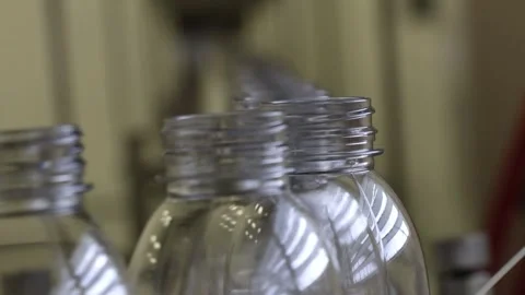 Moving row of empty plastic bottles for a Fruit Juice during factory process, cl Stock Footage 242435771