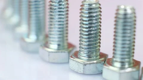 Moving row of galvanized metallic screws close-up. Stock Footage 141384231
