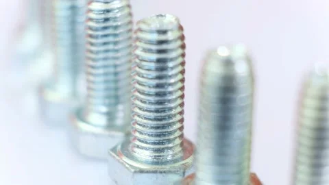 Moving row of galvanized metallic screws close-up. Stock Footage 141440415