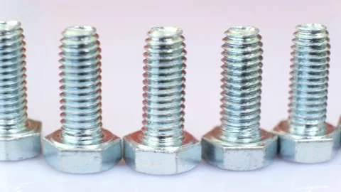 Moving row of galvanized metallic screws close-up. Stock Footage 142343641