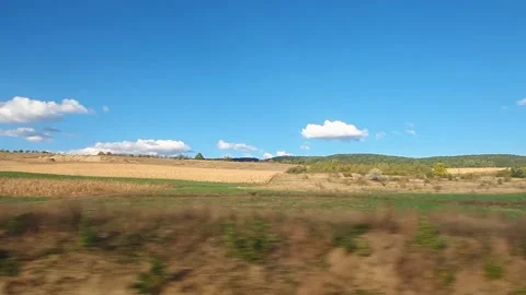 Moving rural scenery as seen through the vehicle window on the road, alongside a Stock Footage 140093247