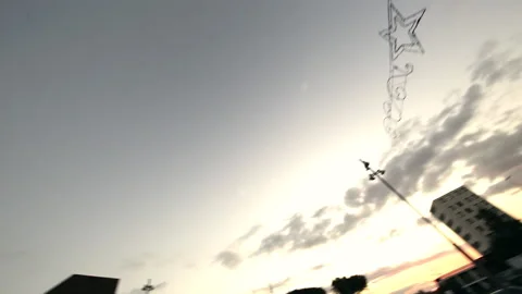 Moving scene of a square surrounded by buildings a church and decorations Stock Footage 132617529