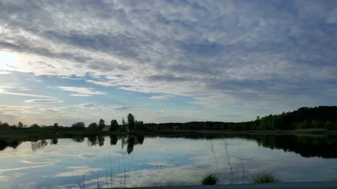 Moving scenery seen through windows of vehicle, mirror-smooth lake reflecting Stock-Footage 137532984