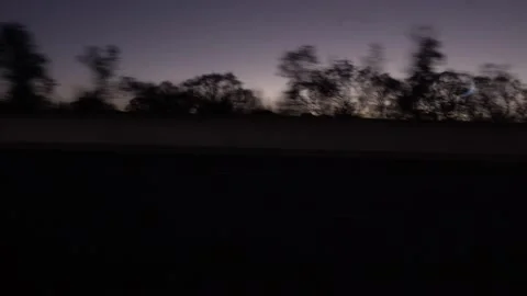 Moving scenery seen through the windows of a vehicle at night. A passenger's  Stock Footage 138717592
