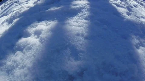 Moving shadows on snow - Timelapse Stock Footage