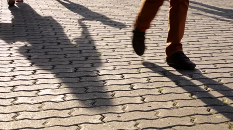 Moving shadows of walking people and children legs. Vídeo Stock 44774780