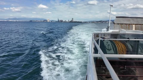 A moving ship looking back at the white water wake in the deep blue sea. 스톡 동영상 337277257