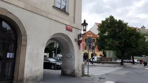A moving shot along a street in old town. Street view with people and traffic. Stock Footage 166310397
