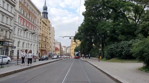 A moving shot along a street in old town. Street view with people and traffic. Stock Footage 166404738