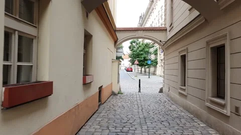 A moving shot along a street in old town. Street view with people and traffic. Stock Footage 166404803