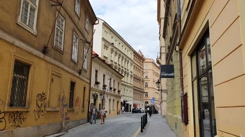 A moving shot along a street in old town. Street view with people and traffic. Stock Footage 166405626