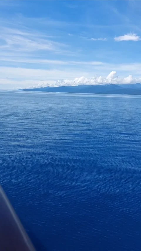 Moving shot approaching tropical forest mountains and ocean. Stock Footage 346215259